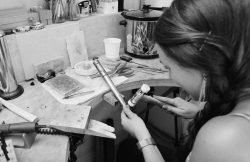 Cornwall Jewellery - Steph working at her bench, hammering a wedding ring on a mandrel