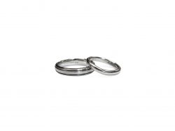 2x wedding rings Platinum black grooves and curved to fit on a white background