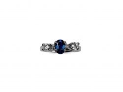 Platinum engagement ring with Oval Sapphire and heirloom Diamond on a white background