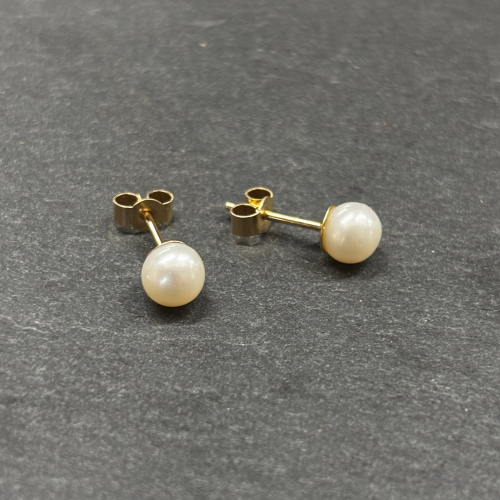 9ct Yellow Gold Earrings wih Cultured pearl Cornwall Jewellery On slate background