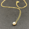 9ct Yellow Gold Necklace with Cultured pearl 2 on slate background