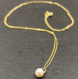 9ct Yellow Gold Necklace with Cultured pearl on slate background