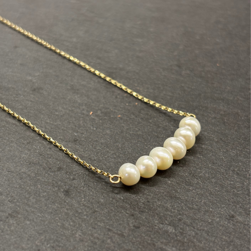 9ct Yellow Gold Necklace with Cultured pearls Cornwall Jewellery on slate background